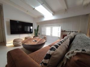 a living room with a couch and a coffee table at Charming loft in the heart of El Carmen Valencia in Valencia