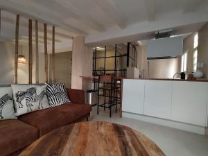 a living room with a couch and a table at Charming loft in the heart of El Carmen Valencia in Valencia