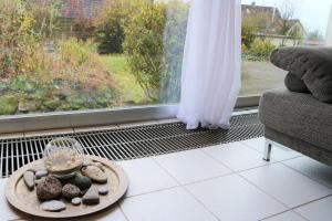 a room with a window and a plate with rocks on it at LIVING .... Bungalow mit großem Garten . in Halver