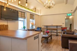 a large living room with a flat screen tv at Lakes Boutique Hostel Apartment Windermere in Windermere