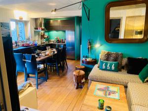 a living room with a couch and a table and a kitchen at Cocon alpin, Situation top, Chalet Reine des neiges in Megève