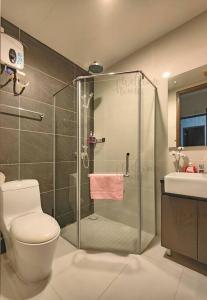 a bathroom with a shower and a toilet and a sink at Amberside, Country Garden Danga Bay Homestay by WELCOME HOME in Johor Bahru