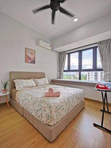 a bedroom with a bed and a ceiling fan at Amberside, Country Garden Danga Bay Homestay by WELCOME HOME in Johor Bahru