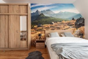 ザコパネにあるApartamenty INTERDOMのベッドルーム1室(ベッド1台付)と山の壁画