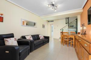 a living room with a couch and a table at A beautiful 2 bedroom townhouse - Las Cerezas in Ciudad Quesada