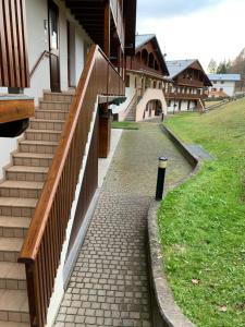 a brick walkway next to a building with stairs at Casa Francesca - Relax nel cuore delle Dolomiti in Pieve di Cadore