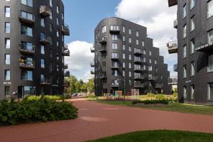 two tall apartment buildings with a playground between them at TartuKodu Riia20A-8 in Tartu