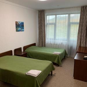 Ein Bett oder Betten in einem Zimmer der Unterkunft Олимпийский центр Акбулак