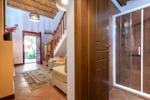 a bathroom with a shower and a glass door at The Varos Residences Hotel in Város