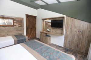 A bed or beds in a room at THE SARIGERME INN