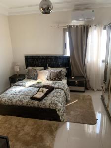a bedroom with a bed and two night stands at Résidence Moussirou 2 in Dakar