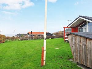 a pole in a yard next to a house at 6 person holiday home in Vinderup in Vinderup