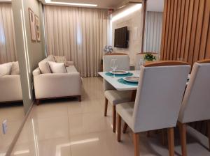 a dining room and living room with a table and chairs at Rio Park Avenue Residence, Piedade - By TRH Invest in Recife