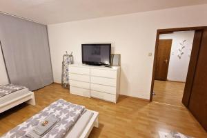 a living room with a television on a dresser at Nice Apartments in Gummersbach in Gummersbach