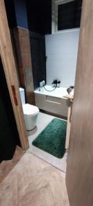 a bathroom with a toilet and a sink at Private Apartament Wroniecka 6 in Poznań