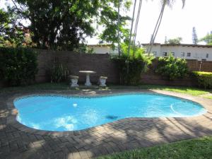 a small blue swimming pool in a yard at Luwandla 12 in St Lucia