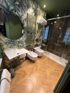 a bathroom with two sinks and a toilet and a shower at Bellacorte Gentiluogo per Viaggiatori in Parma