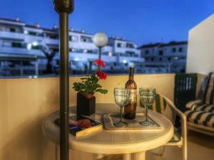 a table with a bottle of wine and two glasses at Apartamento vacacional Paradise in Arona