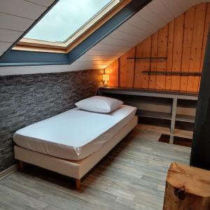 a bedroom with a bed and a skylight at Gîte du pré forestier in Saulxures-sur-Moselotte