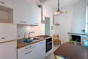a kitchen with white cabinets and a sink and a stove at Vallevo 42 - YourPlace Abruzzo in San Vito Chietino