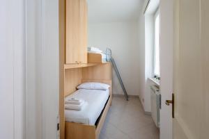 a small room with a small bed and a window at Vallevo 42 in San Vito Chietino