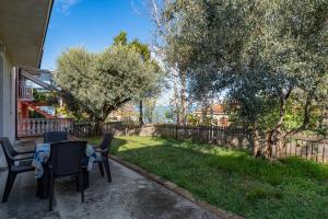 a patio with two chairs and a table in a yard at Vallevo 42 - YourPlace Abruzzo in San Vito Chietino