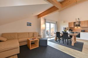 a living room with a couch and a table at Landhaus am See Appartement LH 05 in Schwangau