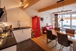 a kitchen and living room with a red refrigerator at Chalet am Breitenberg Appartement CB 08 in Pfronten