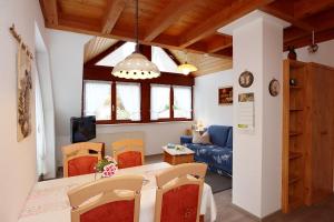 a living room with a table and a blue couch at Haus Gerlinde in Zell am Harmersbach