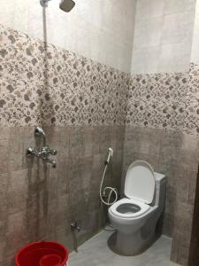 a bathroom with a toilet and a shower at The Taj Homes in Agra