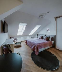 a bedroom with a bed and a table and chairs at LAVilla Osijek in Osijek