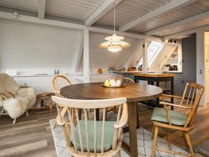 a kitchen and dining room with a table and chairs at 5 person holiday home in Roslev in Roslev