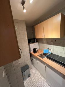 a kitchen with a sink and a counter top at Zentral gelegene Apartments am Schillerplatz MG30 und MG31 in Mönchengladbach +11 photos
