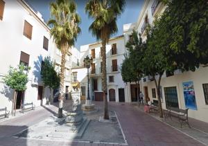 a city street with palm trees and a building at DS San Miguel Centro de Córdoba in Córdoba