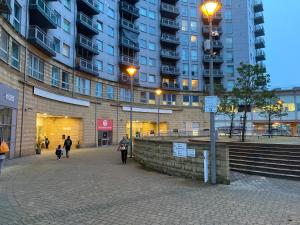 a group of people walking in front of a building at Cosy 2 bed flat near train station Basingstoke with FREE Parking! in Basingstoke