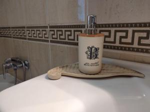 a coffee cup sitting on top of a sink at Apartments Košević in Osijek +60 photos