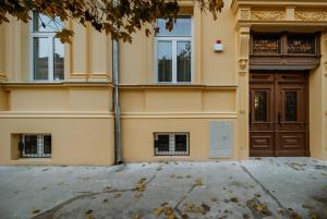 a building with a door and a driveway at LAVilla Osijek in Osijek