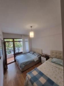 a bedroom with two beds and a window at Thermal Orkide Pansiyon in Yalova