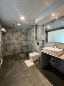 a bathroom with a sink and a toilet at Magpie Libing Grand (MG Marg) in Gangtok