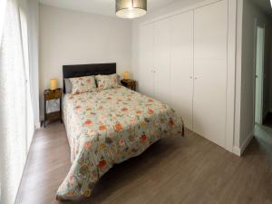 a bedroom with a bed and a white cabinet at La Ermita FjHomeFj in Jerez de la Frontera