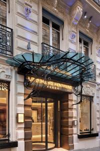 a store front of a building with a revolving door at La Demeure Montaigne in Paris