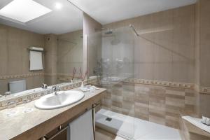a bathroom with a sink and a shower at Elba Vecindario Aeropuerto Business & Convention Hotel in Vecindario +50 photos