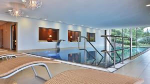 a swimming pool with a glass floor in a house at Hotel Sonnenhof in Lautenbach