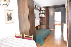 een slaapkamer met een bed en een boekenplank bij Astoria (213 Le) in Lenzerheide