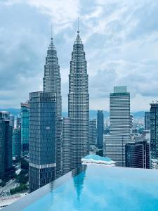 a swimming pool in front of a city skyline at Platinum Suites Tower 2 KLCC in Kuala Lumpur