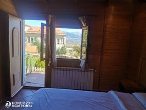a bedroom with a large window with a view at Hotel Sierra Oriente in Guadarrama