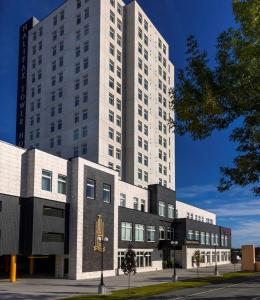 a tall white building in front of a building at Halifax Tower Hotel & Conference Centre, Ascend Hotel Collection in Halifax