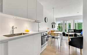 a kitchen and living room with a sink and a table at Gorgeous Apartment In Aarhus C With Wifi in Aarhus