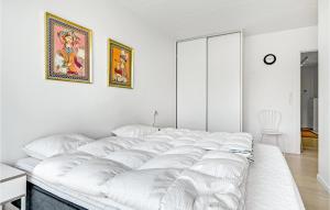 a large white bed in a white room with at Gorgeous Apartment In Aarhus C With Wifi in Aarhus