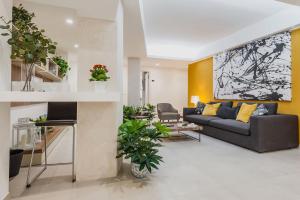 a living room with a couch and a table at Archimede's Rooms in Syracuse